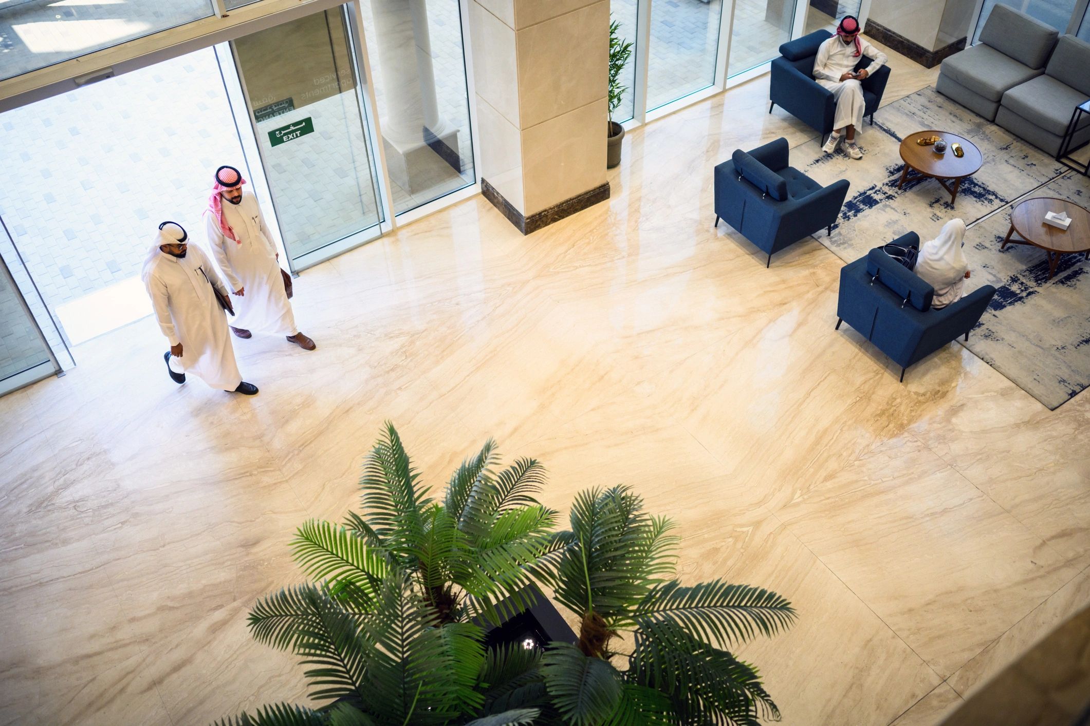 Business guests moving through a grand hotel lobby